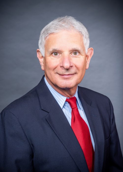Philip Waldman wearing a suit and tie